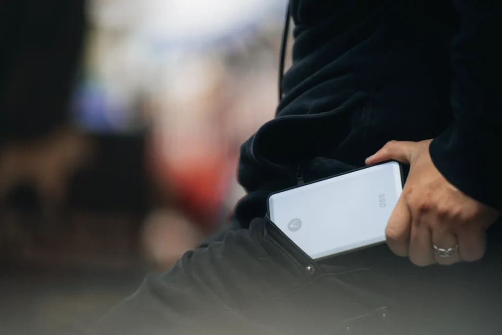A man places an external (portable) SSD into his pocket